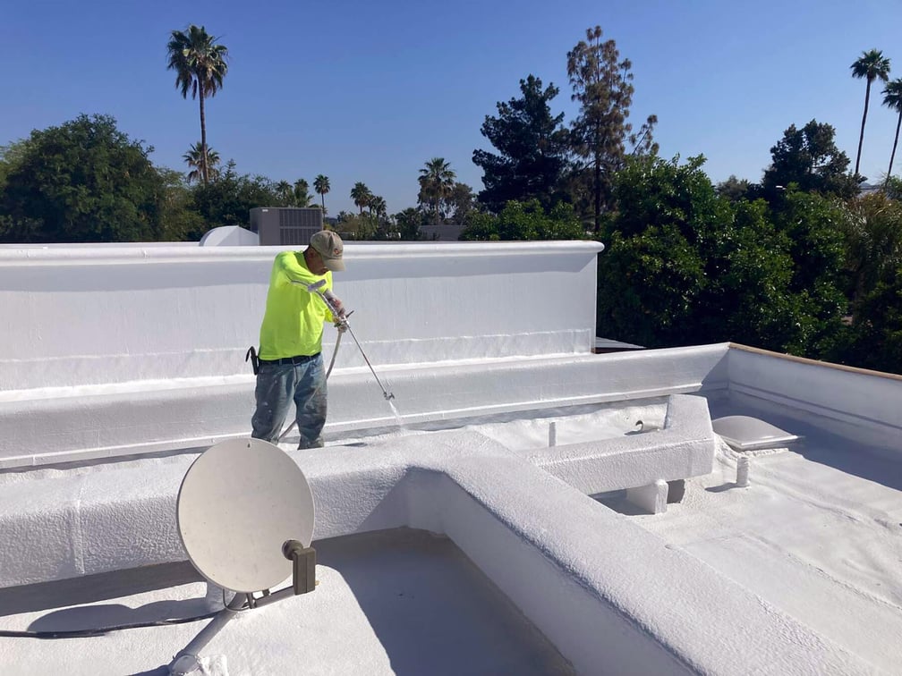 TraVek Roofing Technician Applying Foam to Flat Roof