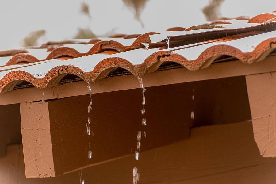 water dripping off of roof tiles